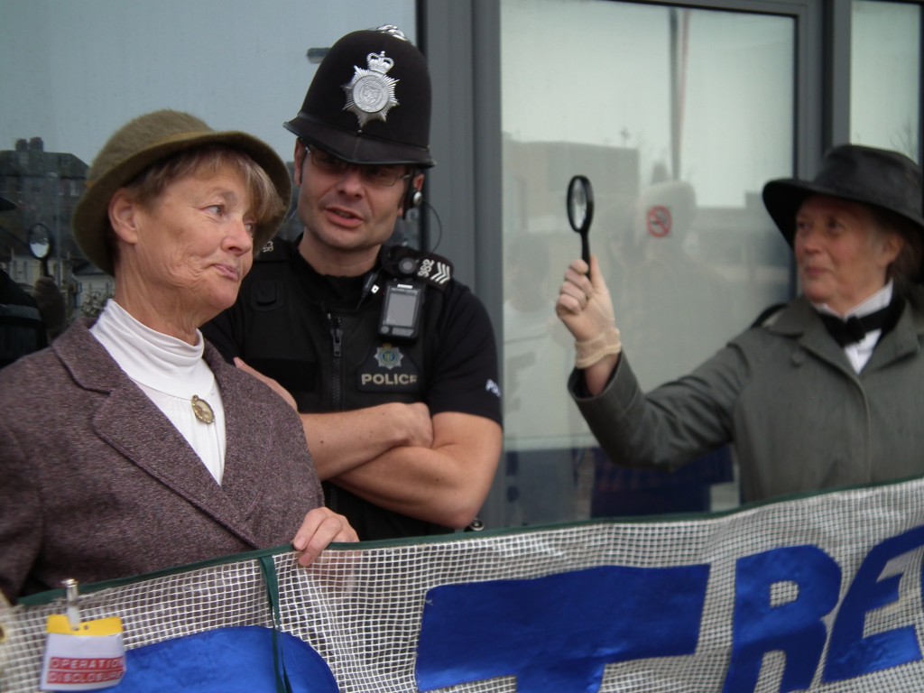 Sherlock Holmes searches for secret HS2 documents at rail summit in Hastings, watched by Miss Marple, Inspector Poirot and Kojak. 31 Mar 2014 (credit: Combe Haven Defenders)