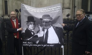 Martin Tett and Nick Rose (leaders of Buckinghamshire County and Chiltern District Councils) hold up a banner depicting Justine Greening and Patrick McLoughlin as Laurel and Hardy